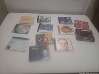 All ten jewel case CDs laid out on table