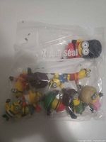 Bagged assortment of Minion figurines showing variety of costumes