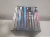 Front view of 11 DVD spines showing most titles