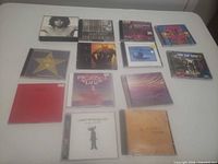 Group shot of all 14 audio CDs in jewel cases