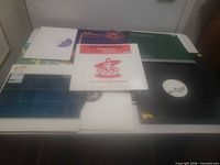 All records spread out on table, front and back rows visible