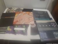 All five record sleeves displayed on table