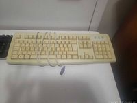 Beige Dell PS/2 keyboard coiled cable visible