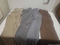 Four pairs dress pants laid out showing colors