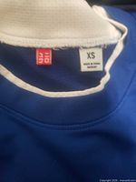 Blue Uniqlo garment tag showing size XS
