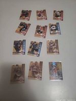 Full layout of all cards on table including Pokemon card in top-loader