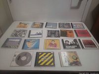 All CDs displayed on table in 4x5 grid
