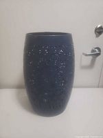 Full front view of navy blue ceramic vase