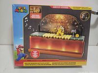 Front of box showing Super Mario Deluxe Bowser Battle Playset, Bowser figure displayed on lit platform