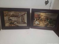 Front view of both framed reverse-glass paintings