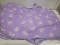 Front view of crumpled purple pillowcase displaying Tinker Bell print