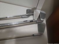 Club heads showing groove wear and scratches