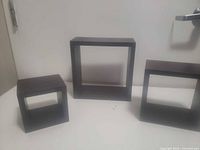 all three black square cube shelves grouped to show size differences