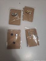 All four packaged jewelry items on cards