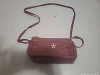 Front view showing overall bag, strap, gold star emblem