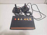 Front view of Atari Flashback 2 console and both joysticks