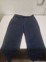 Full view of navy JAG jeans laid flat showing overall condition and style