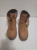Front view of tan/brown lace-up ankle boots
