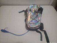 Full view of holographic hydration backpack with tube visible