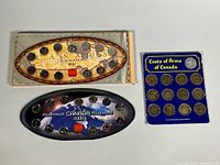 Overview of three presentation boards: 1999 and 2000 quarter sets and Shell medallion board