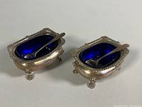 Two Birks sterling salt cellars with cobalt liners, spoons inside