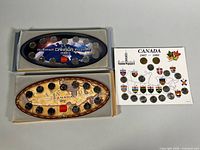 All three 13-coin sets: two oval Millennium holders with boxes, one Confederation card