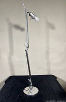 Full view of Artemide Tolomeo lamp showing articulated arm and base