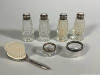 Group shot of all seven items: brush, two salt cellars, four shakers