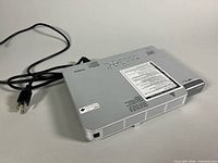 Top view of projector showing control buttons, built-in power cord