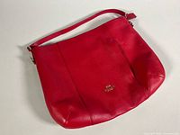 Full view of the red Coach shoulder bag