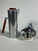 Pitcher and candleholder side by side