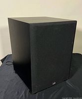 Subwoofer with grille installed, front-right view