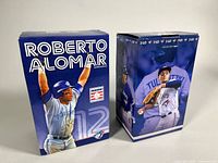 Front view of both boxed bobbleheads showing player names and graphics