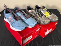 Both pairs of New Balance shoes on boxes