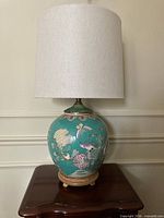 Full view of turquoise famille rose vase lamp with shade