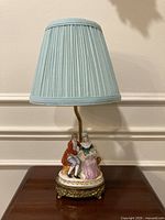 Full view of lamp with shade on tabletop