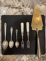 Group shot of all six pieces aligned on black background