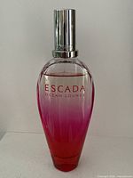 Full view of gradient pink Escada Ocean Lounge bottle