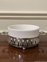 Side view of assembled butter dish showing pierced sterling holder and ceramic bowl