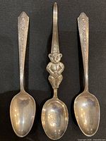 Front view of three sterling spoons showing bowls and handles
