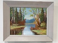 Framed oil painting on wall showing overall size and frame