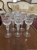 Full set of six crystal wine goblets on table