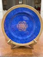 Full view of cobalt blue dinner plate on stand