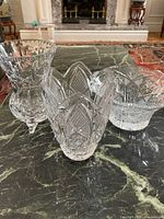 Three crystal pieces grouped on marble surface