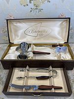 Closed case opened showing upper and lower trays with bar tools