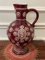 Full view of pitcher showing shape, glaze and decoration