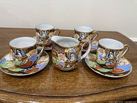 Full set: four cups on saucers with creamer in centre