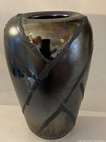 Front view of vase showing metallic glaze and diagonal textured bands