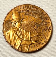 Obverse of brass souvenir token showing pilgrim and dates 1630-1930