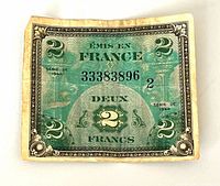 Obverse of 2 Franc note showing denomination, serial, wear